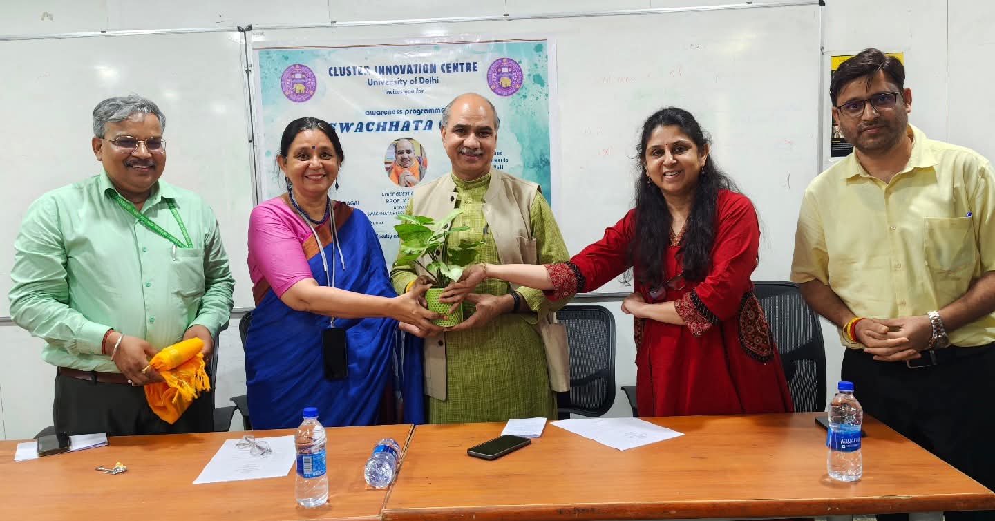 Members of the CIC community presenting a plant at a campus event